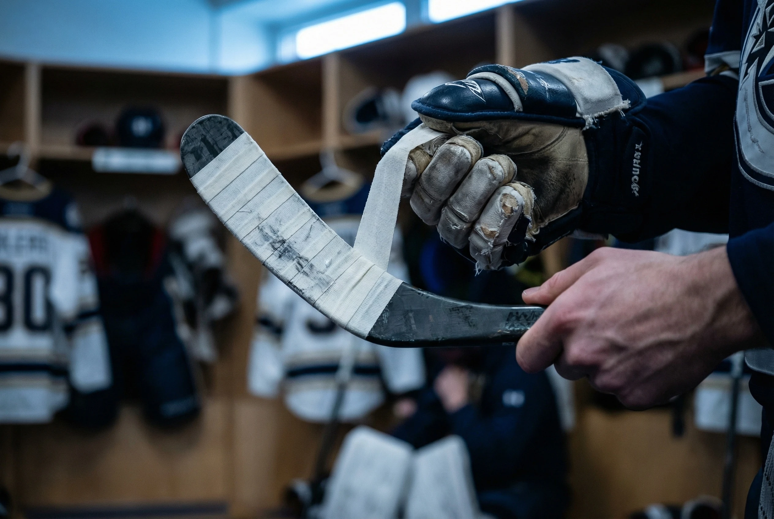 Close up of black custom hockey tape on stick blade showing fabric texture